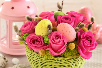 Woman shows how to make Easter table decoration with roses, moss and catkins, tutorial.