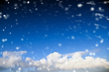 Blue sky with snowfall and clouds