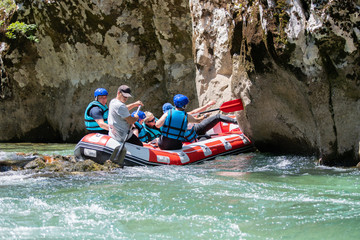 Fototapeta na wymiar Rafting team stucked on the river