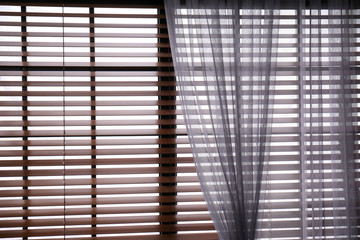 Window with beautiful curtain and blinds, closeup