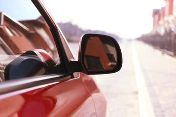 Side rear view mirror of modern car outdoors