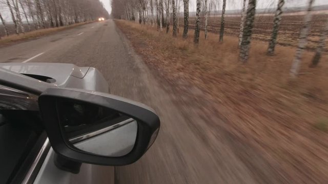 Pov of car drive on the forest road. Camera mounted outside of a car