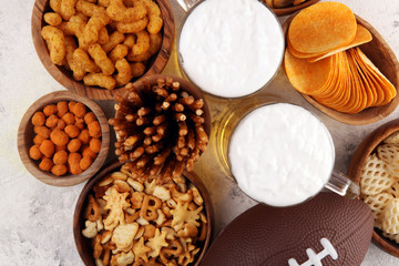 Chips, salty snacks, football and Beer on a table. Great for Bowl Game snack projects.