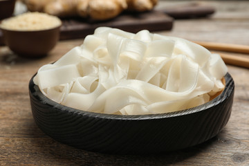 Tasty rice noodles on wooden table, closeup