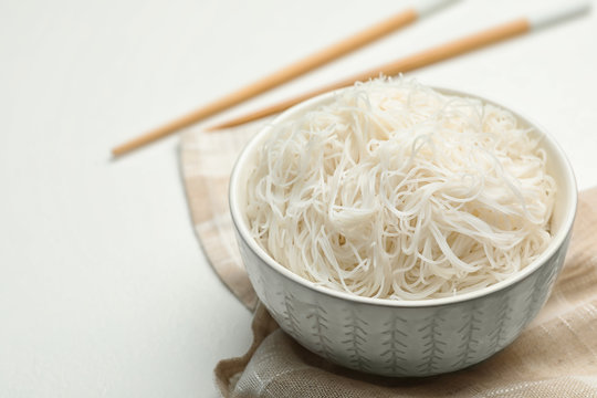 Tasty cooked rice noodles on white table