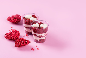 Delicious and beautiful dessert, red velvet in cups. Hearts of white chocolate. Valentine's Day.