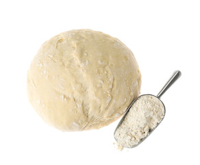 Raw dough for pastries and flour isolated on white, top view