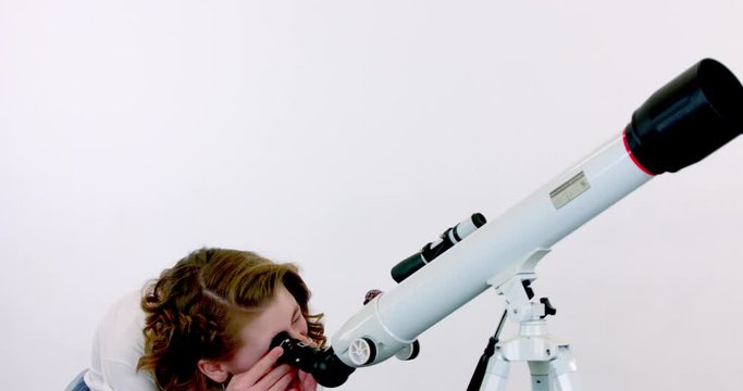 Girl posing with a telescope on a white isolated background