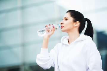 Sport outdoor. Woman Drinking Water After Running