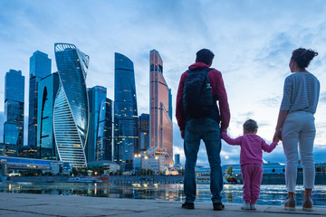 Family looks at the skyscrapers in the center of Moscow. Moskva-city. High-rise buildings of...