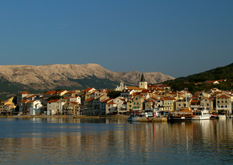 Fototapeta na wymiar Panoramic view of the Small town of Baska and marina . Croatia vacation. Island Krk. Adriatic coast, Croatia, Europe. Summer vacation. Relaxation Concept. Beaches of Croatia. 