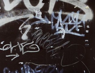 graffitis on brown metal door