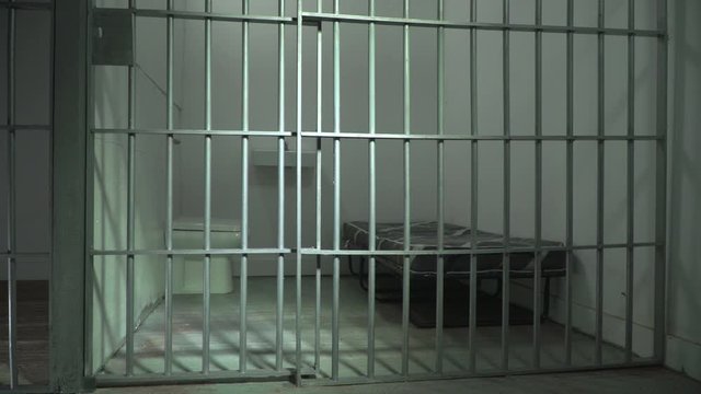 Empty Prison cell & Jail door. Camera Dolly Shot in Cellblock with no people or prisoners. Low down