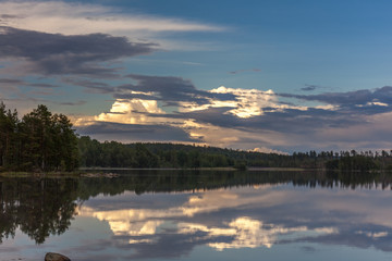 The sun setting over the lake with some interesting clouds in the sky. Sweden