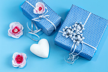 Gift box Packed in blue paper on a blue background .