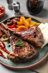 Delicious grilled ribs served on grey table