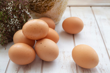 Fresh raw farm eggs on a wooden rustic background