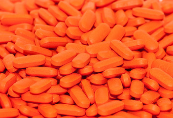 A closeup of orange pills or medicine