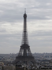 View of the Eiffel Tower as seen from the Arc de Triomphe in Paris, France on a cloudy day
