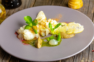 rustic wooden background, top and side, on a plate, halibut fish appetizer, olive tapenade,...