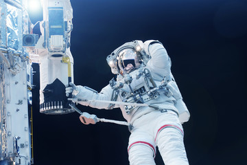Astronaut in outer space at the space station. Elements of this image were furnished by NASA.