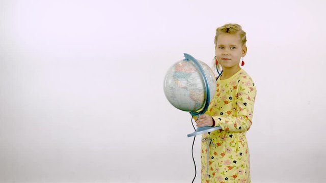 Girl posing with a globe on a white isolated background