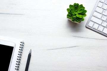 White desk office with laptop, smartphone and other work supplies with cup of coffee. Top view with...