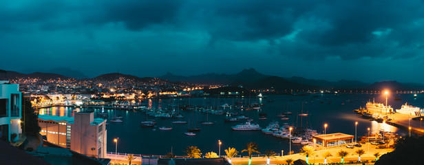 Cape Verde, Sao Vicente Island. Twilight panoramic view of Mindelo city port town with many boats in the lagoon