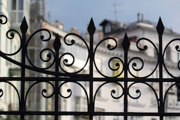 Old rusted iron fence with ornate curls. Architecture