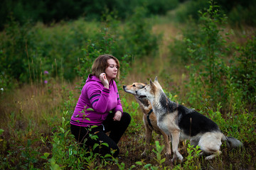 Woman training dogs in countryside in field