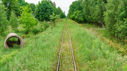 Railway top view. Railroad and green grass on the sides. The part of narrow gauge rail track for...