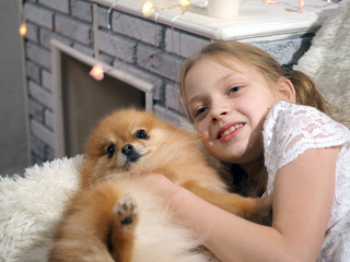 Portrait of a child with a dog in a home interior