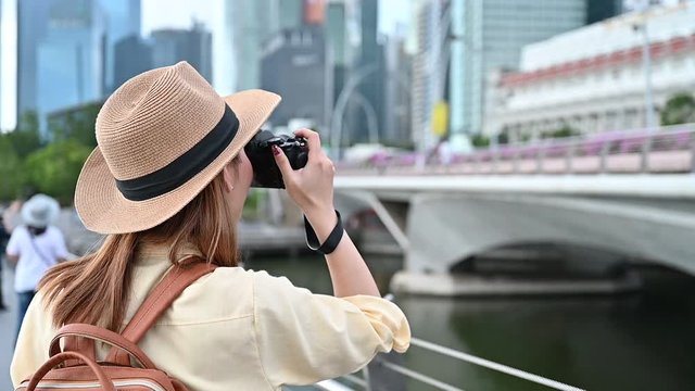 Young woman photographing city of Singapore