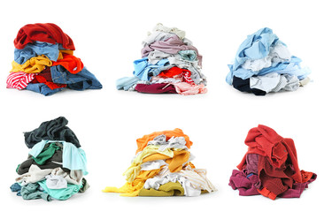 Heaps of different clothes on white background