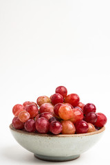 Red Grapes In Small Round Ceramic Bowl