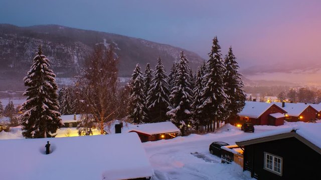 Hafjell, Norway. Aerial view of ski resort Hafjell in Norway at sunrise in  winter. Time-lapse of houses with mountains at the background, zoom in