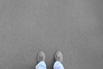 Person standing on asphalt road, top view. Concept of choice