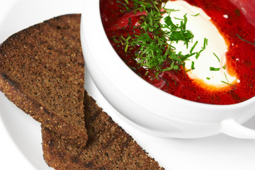 Borscht in a bowl with bread