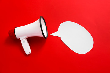 Megaphone with speech bubble on color background