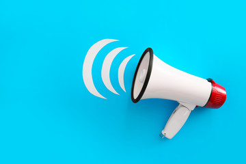 Modern megaphone on color background