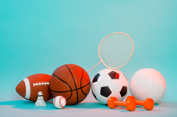 Sports equipment, rackets and balls on blue background and copy space.