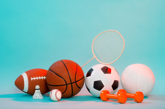 Sports equipment, rackets and balls on blue background and copy space.
