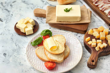 Slices of bread with fresh butter and cheese on white background