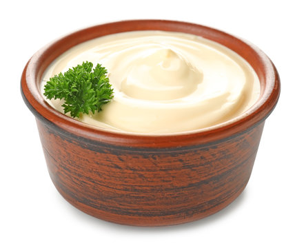 Bowl of tasty sauce on white background