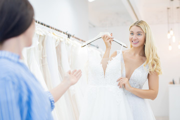 Choosing wedding dress in shop
