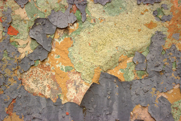  Wall of an old building with ragged green and orange paint