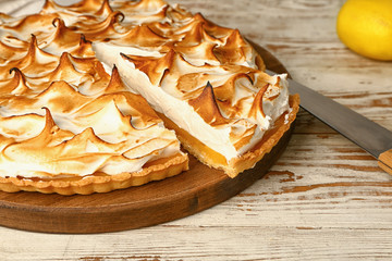 Tasty lemon pie on wooden table