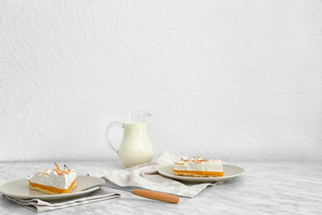 Tasty lemon pie with milk on table
