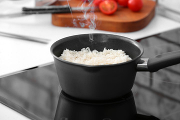 Preparing of tasty rice in kitchen