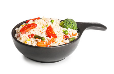 Boiled rice with vegetables in frying pan on white background